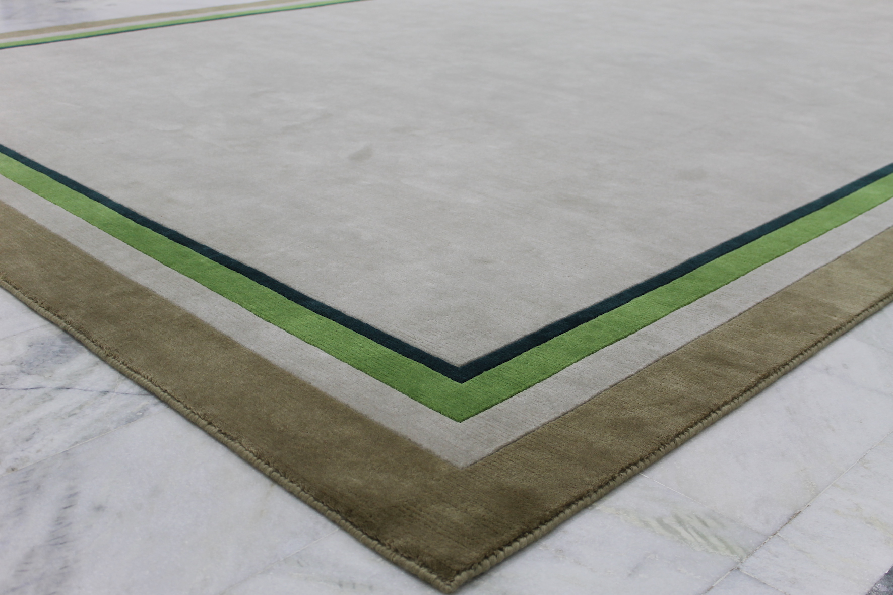 Green neutral border rug